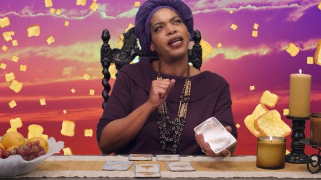 Miss Cleo thinking hard while reading tarot.